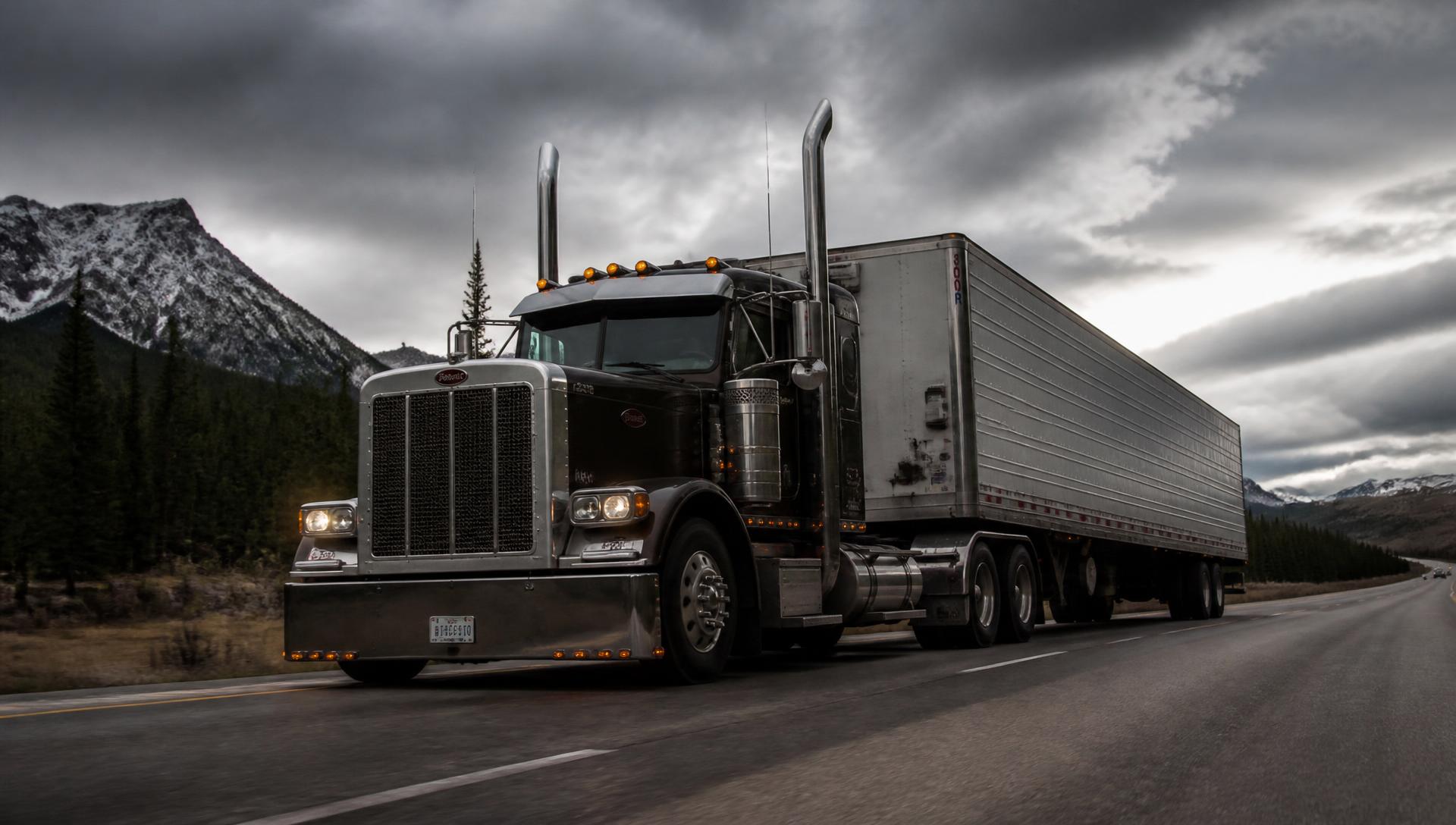 American Peterbilt semi truck on an open interstate highway